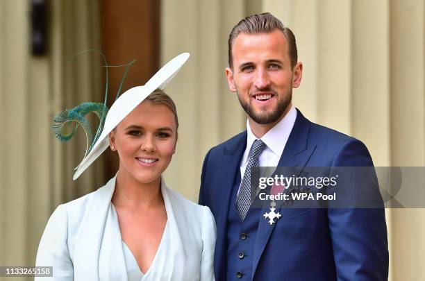 England football captain Harry Kane with his partner Kate Goodland after being made an MBE by the Duke of Cambridge at an investiture ceremony at...