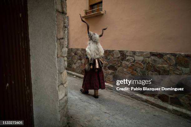 Man carrying billy goats’ horns and goat skins known as ‘Trangas’ takes part in Bielsa traditional carnival on March 02, 2019 in Bielsa, Huesca...