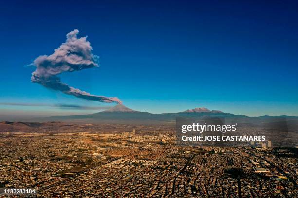 The Popocatepetl Volcano spews ash and smoke as seen from Puebla, central Mexico, on March 28, 2019.