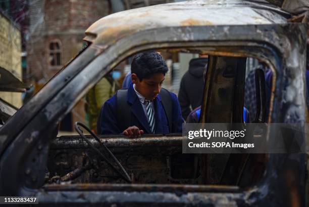 Kashmiri school boy seen inspecting a damaged vehicle after a blast in Srinagar. Reports said that panic gripped in Alochi Bagh area of Srinagar when...