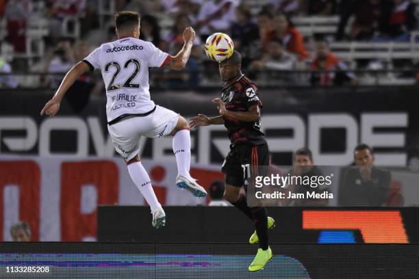 Nicolas De La Cruz of River Plate heads the ball against Cristian Insaurralde of Newell's All Boys during a match between River Plate and Newell's...