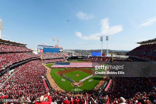 Fans cheer during the National Anthem on Opening Day between the Pittsburgh Pirates and the Cincinnati Reds at Great American Ball Park on March 28,...