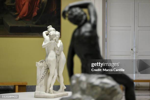 The statue of "The Three Graces" and the "Sleeping Satyr" out of focus, by the sculptor Canova, inside the exhibition at the Archaeological Museum of...