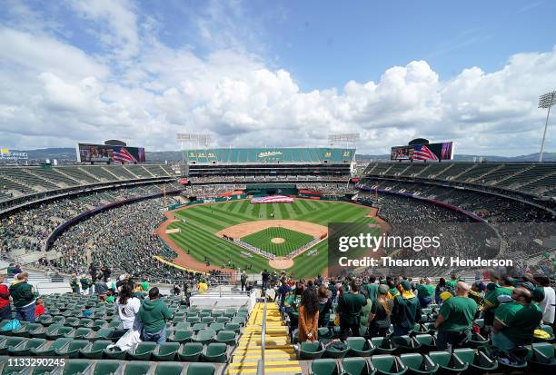 An overview of the Coliseum while the Los Angeles Angels of Anaheim and Oakland Athletics stands for the National Anthem on Opening Day of Majoar...