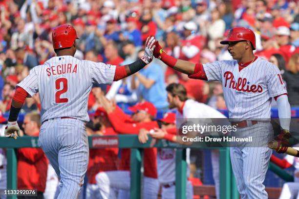 Jean Segura of the Philadelphia Phillies is congratulated by Cesar Hernandez after scoring a run in the fourth inning against the Atlanta Braves on...