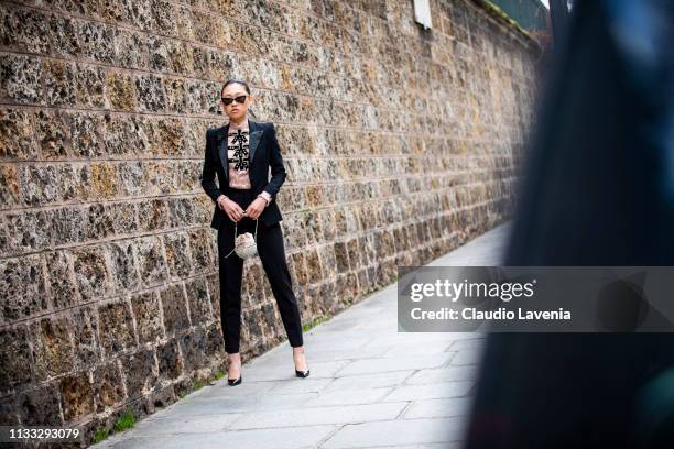 Jaime Xie, wearing black blazer and pants, pink shirt, back Saint Laurent heels and sunglasses, is seen outside Vivienne Westwood on Day 6 Paris...