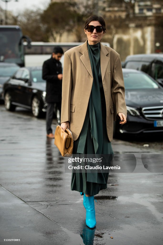 Irina Linovich, wearing beige blazer, light blue heels and green ...
