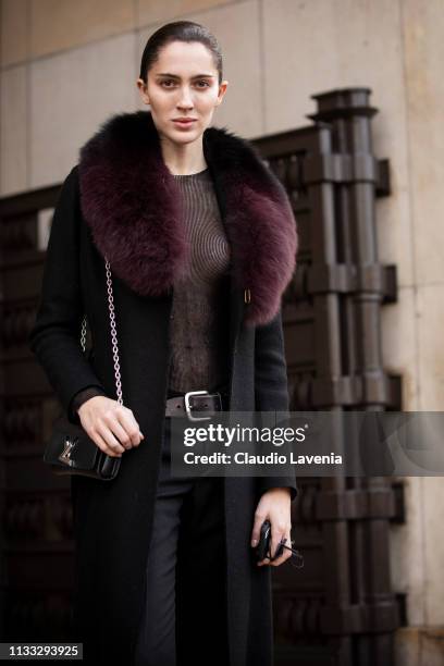 Teddy Quinlivan, wearing a sheer black top, black pants, black Louis Vuitton bag and black coat with fur details, is seen outside Haider Ackermann on...