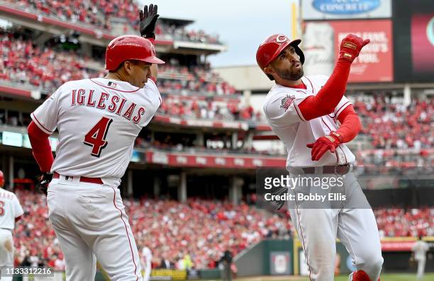 Jose Peraza of the Cincinnati Reds and Jose Iglesias of the Cincinnati Reds celebrate after Peraza hit a three run home run during the seventh inning...