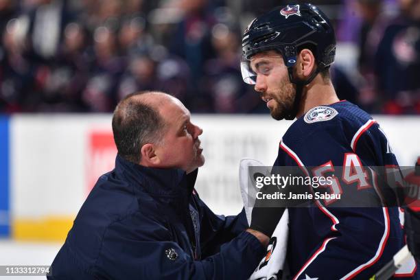 Columbus Blue Jackets Head Athletic Trainer Mike Vogt attends to Adam McQuaid of the Columbus Blue Jackets during the second period of a game against...