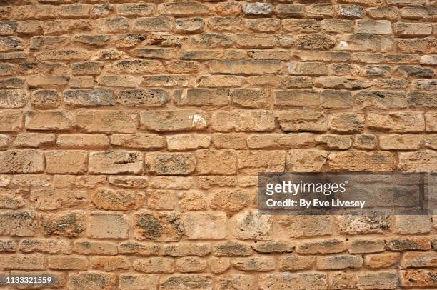 medieval stone wall background - beige brick stock pictures, royalty-free photos & images