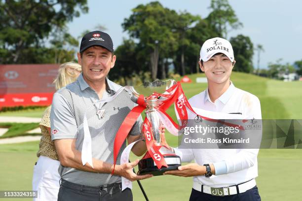 Sung Hyun Park of South Korea is presented with the winner's trophy by Tony Cripps, CEO HSBC Singapore after the final round of the HSBC Women's...