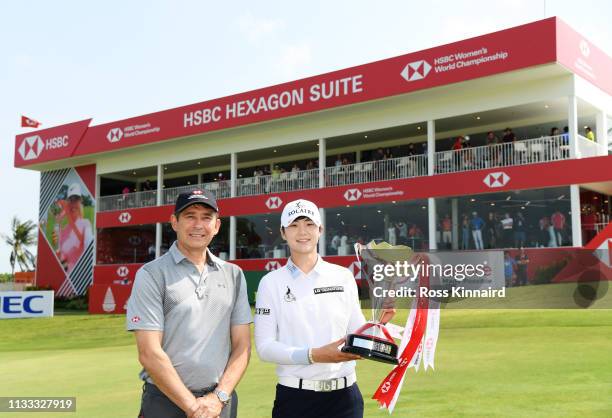 Sung Hyun Park of South Korea celebrates with Tony Cripps, CEO HSBC Singapore, and the winner's trophy after the final round of the HSBC Women's...