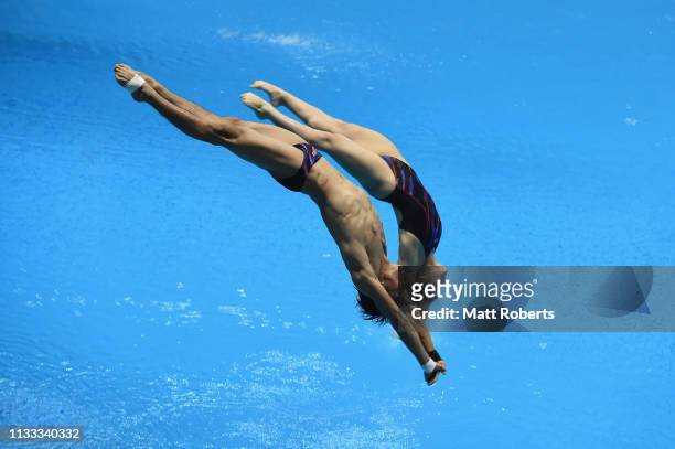 Muhammad Syafiq Puteh and Nur Dhabitah Binti Sabri of Malaysia compete during the Mixed 3m Synchro Springboard Final on day three of the FINA Diving...