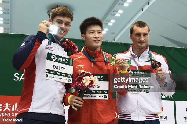 Silver medalist Thomas Daley of Great Britain, gold medalist Jian Yang of China and bronze medalist Aleksandr Bondar of Russia pose during the medal...