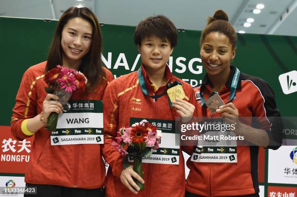 Silver medalist Han Wang of China, gold medalist Tingmao Shi of China and bronze medalist Jennifer Abel of Canada pose during the medal presentation...