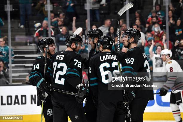 Gustav Nyquist, Logan Couture and Kevin Labanc of the San Jose Sharks celebrate a goal against the Chicago Blackhawks at SAP Center on March 28, 2019...