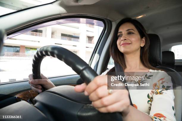 woman driving car - steering wheel stock pictures, royalty-free photos & images