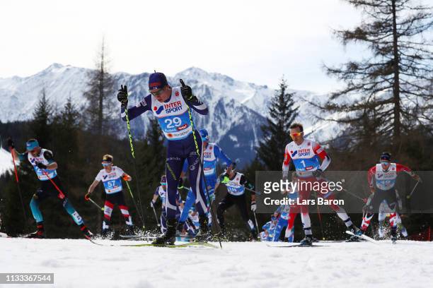 Matti Heikkinen of Finland and Sjur Roethe of Norway compete in the Men's Cross Country 50k race during the FIS Nordic World Ski Championships on...