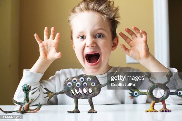 little boy playing with child's play clay - sculptor stock pictures, royalty-free photos & images