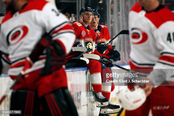 Jamie McGinn and teammate Dryden Hunt of the Florida Panthers sit on the boards during a break in the action against the Carolina Hurricanes at the...