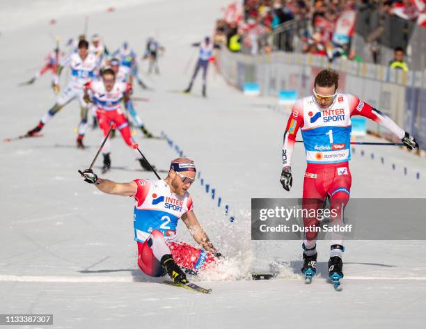 Sjur Roethe of Norway beats Martin Johnsrud Sundby of Norway to the line for third place in the Men's 50km Cross Country mass start during the FIS...