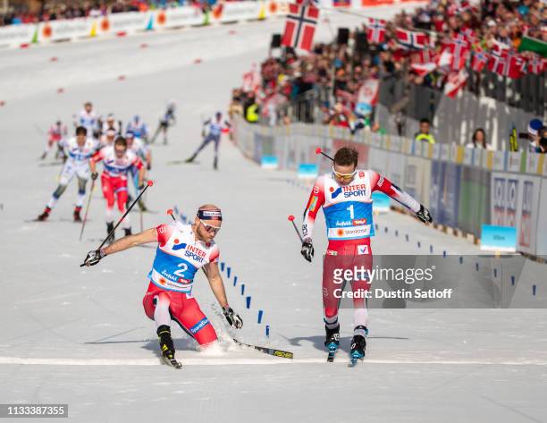 Sjur Roethe of Norway beats Martin Johnsrud Sundby of Norway to the line for third place in the Men's 50km Cross Country mass start during the FIS...