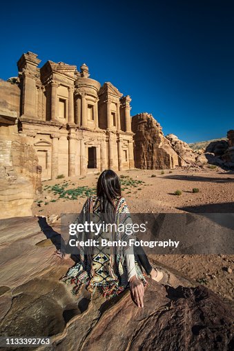 A tourist girl sitting in front of Monastery, Petra, Jordan.