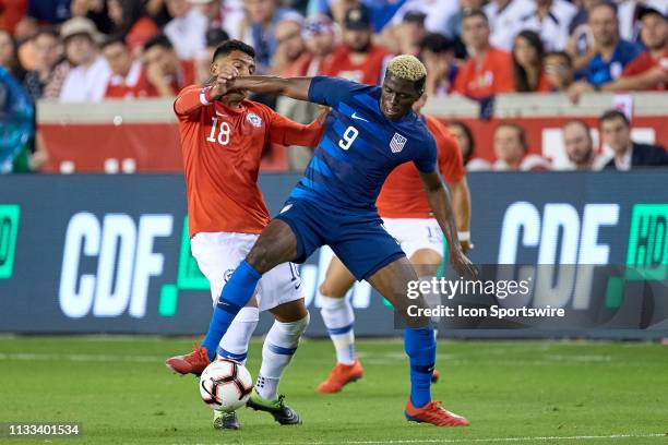 United States forward Gyasi Zardes battles with Chile defender Gonzalo Jara in game action during a friendly International match between Chile and...
