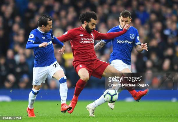 Mohamed Salah of Liverpool is watched by Bernard and Lucas Digne of Everton during the Premier League match between Everton FC and Liverpool FC at...