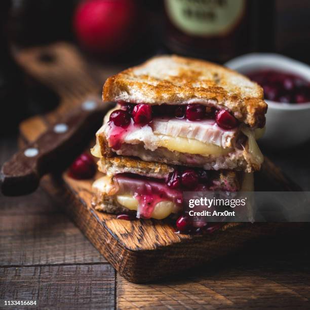 grilled cheese sandwich with turkey and cranberry sauce - stuffing food stockfoto's en -beelden