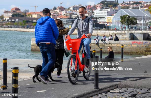 Man rides an Uber-Jump electric bicycle on the Ciclovia Lisboa Cidade by Tagus Ricer in Cais Gás on March 03, 2019 in Lisbon, Portugal. Starting...