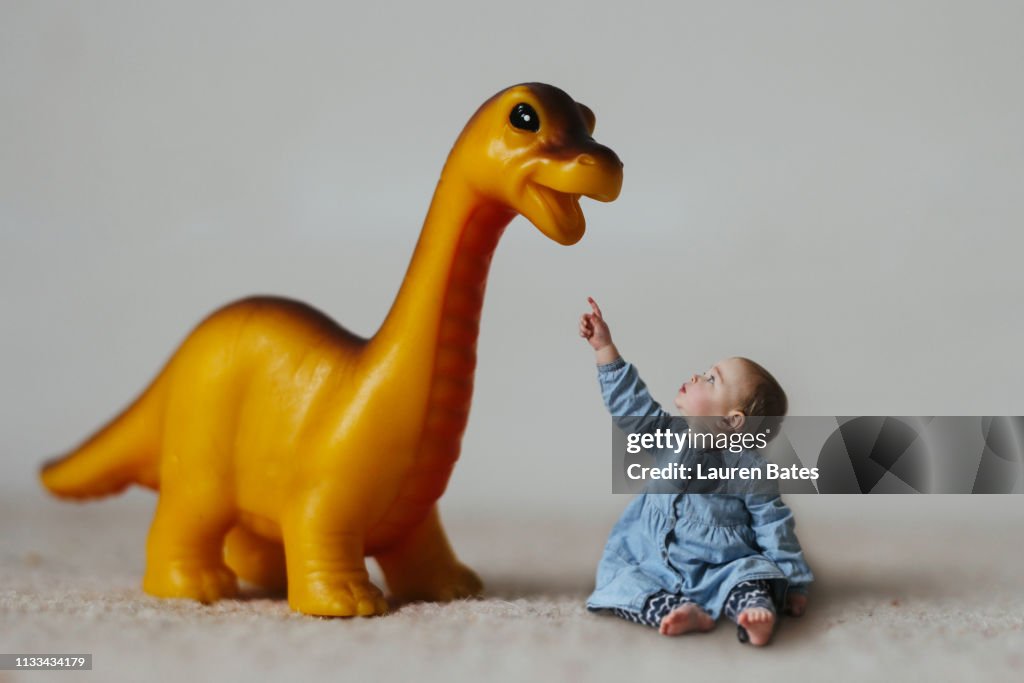 A baby girl and her dinosaur