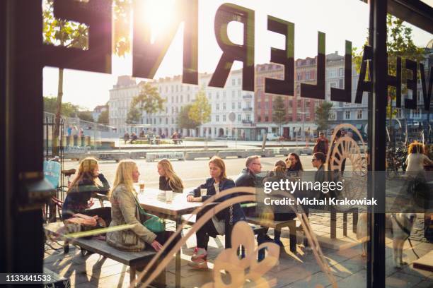 people in sidewalk cafe in copehnagen. - sidewalk cafe stock pictures, royalty-free photos & images