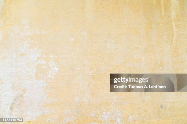 weathered and aged orange concrete wall, paint peeled off, texture background. - stone wall stock pictures, royalty-free photos & images