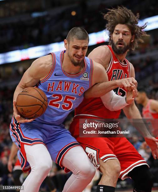 Alex Len of the Atlanta Hawks is fouled by Robin Lopez of the Chicago Bulls at the United Center on March 03, 2019 in Chicago, Illinois. NOTE TO...