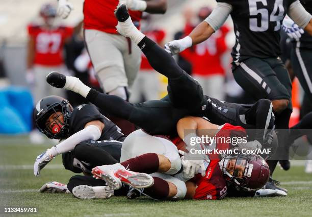 Kenneth Farrow II of the San Antonio Commanders is tackled by Elijah Campbell of the Birmingham Iron during the first half in an Alliance of American...