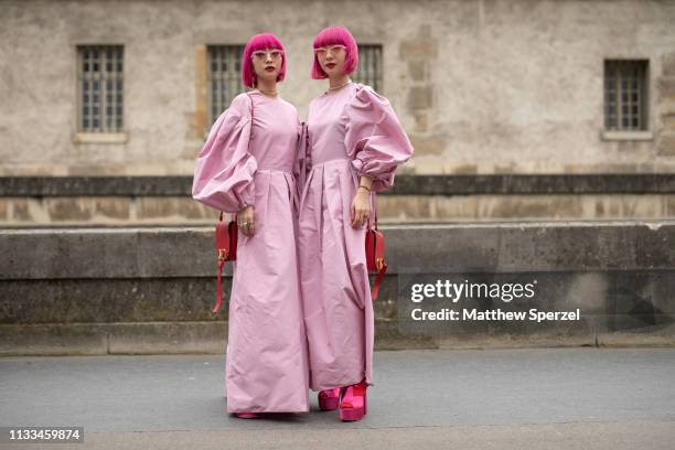 Amiaya are seen on the street attending VALENTINO during Paris Fashion Week AW19 wearing VALENTINO pink dresses on March 03, 2019 in Paris, France.