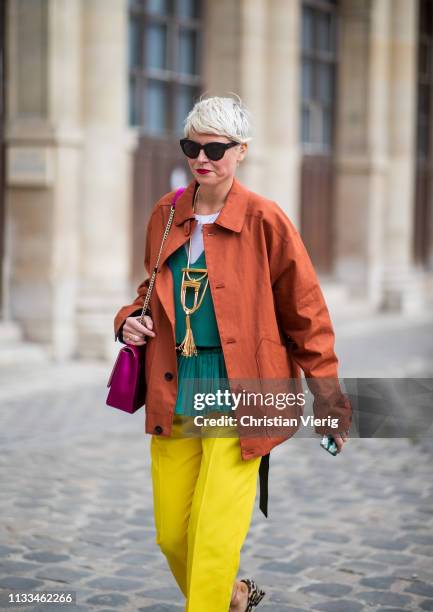 Elisa Nalin is seen wearing yellow pants, orange jacket outside Thom Browne during Paris Fashion Week Womenswear Fall/Winter 2019/2020 on March 03,...