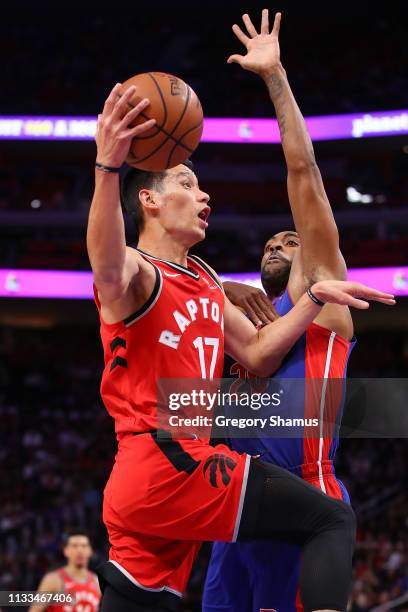 Jeremy Lin of the Toronto Raptors dives to the basket around Wayne Ellington of the Detroit Pistons during the first half at Little Caesars Arena on...