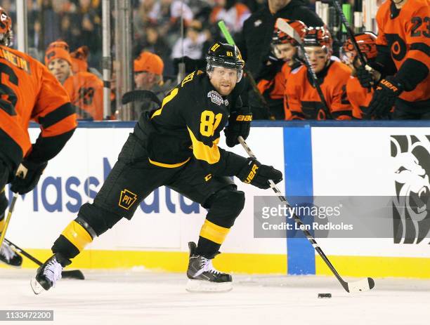 Phil Kessel of the Pittsburgh Penguins skates the puck against the Philadelphia Flyers at the 2019 Coors Light NHL Stadium Series on February 23,...