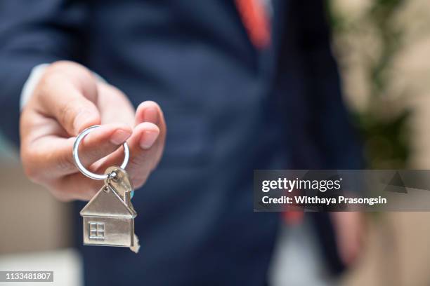 hand holding house key,real estate agent - vermieter stock-fotos und bilder
