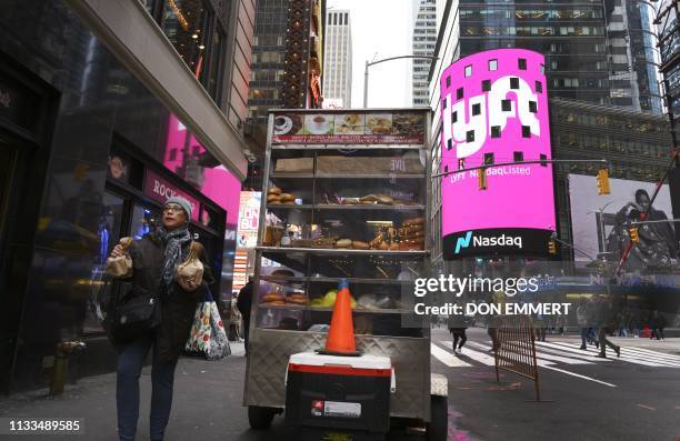 The Lyft logo is shown on the screen at the Nasdaq offices in Times Square on March 29, 2019 in New York. Nasdaq: LYFT, the multimodal transportation...