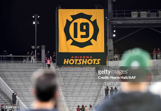 Banner is raised as the 19 Granite Mountain Hotshot fallen firefighters are honored at halftime during the Alliance of American Football game between...