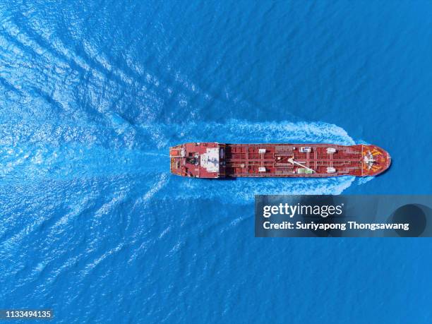 aerial top view oil ship tanker full speed with beautiful wave pattern transportation from refinery on the sea. - industrial sailing craft stock pictures, royalty-free photos & images