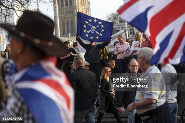Pro-Brexit campaigner waves an anti-European Union flag, while rallying near the Houses of Parliament in London, U.K., on Friday, March 29, 2019. The...