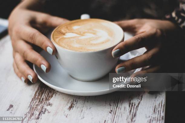 lady's hands holding cup with sth heart-shaped - café au lait stock pictures, royalty-free photos & images