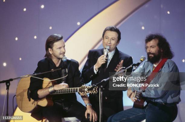 French singer Renaud, television host Michel Drucker and singer-songwriter Antoine on the set of the TV show Stars 90.