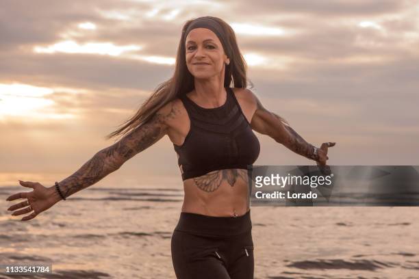 tattooed senior woman during workout - old woman tattoos stock pictures, royalty-free photos & images