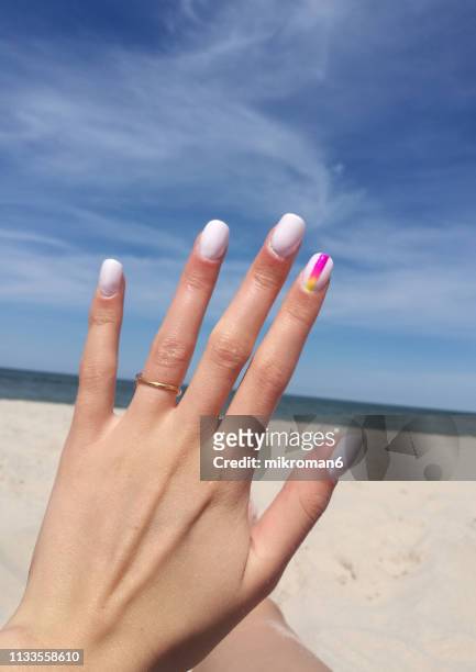 close-up of woman fingers with nail art manicure in white colour - nail art stock pictures, royalty-free photos & images